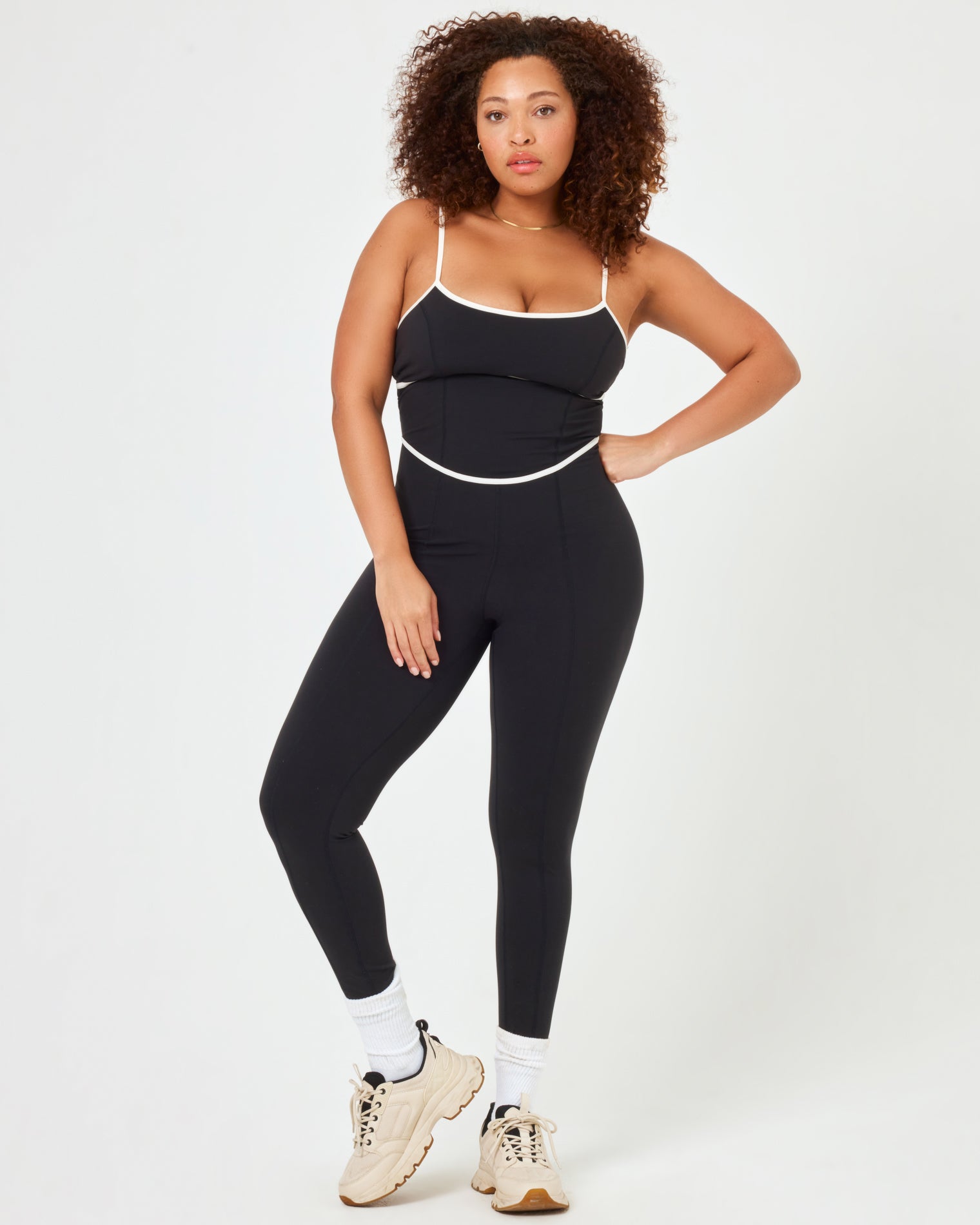 Ace Jumpsuit - Black-Cream Front view of plus size model wearing the Ace Jumpsuit in black-cream with cream contrast piping.