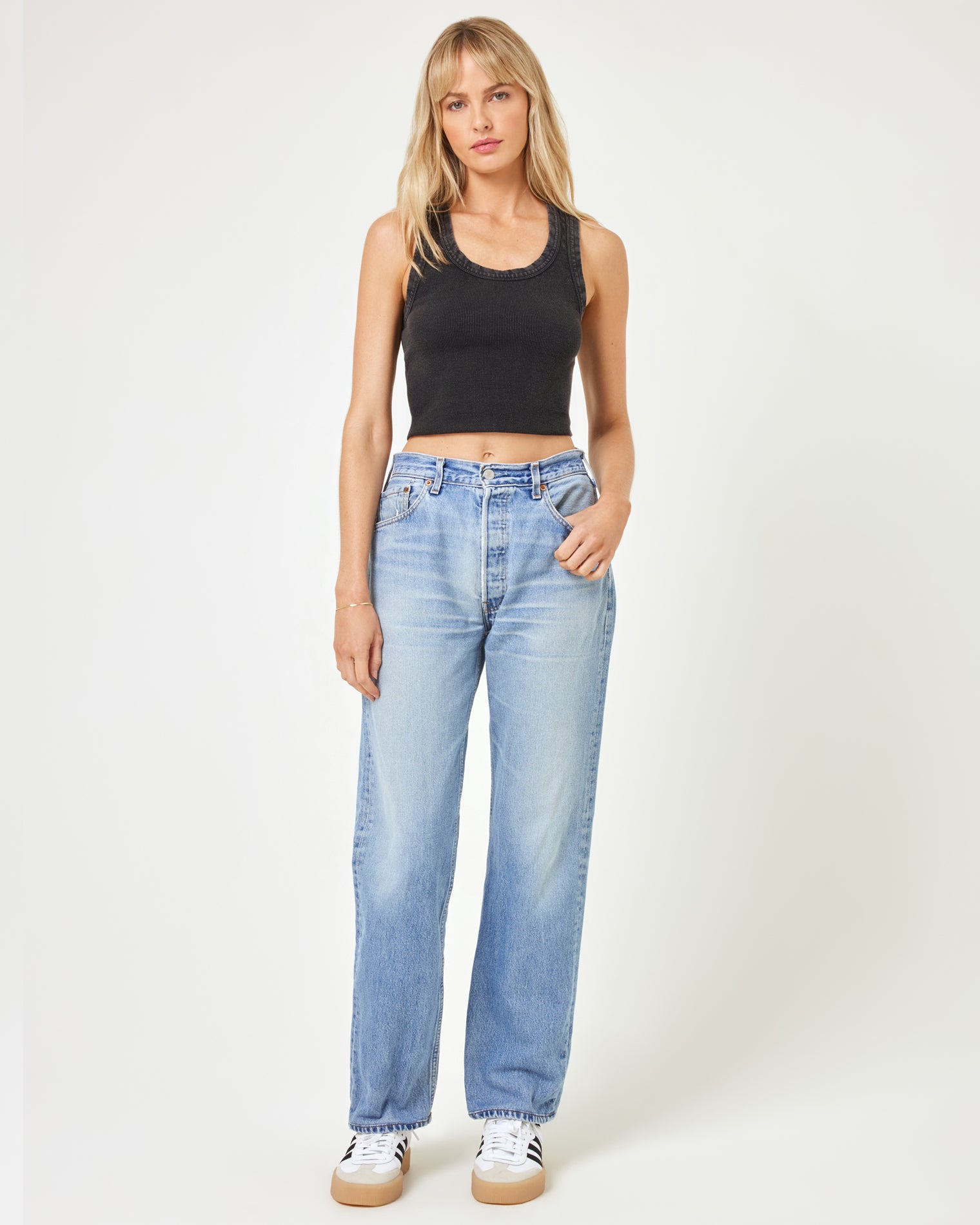 aligrace Brigette Baggy Denim Pant Full body front view of a model wearing the LSPACE aligrace Brigette Baggy Denim Pant in blue, styled with a black ribbed crop tank and sneakers.
