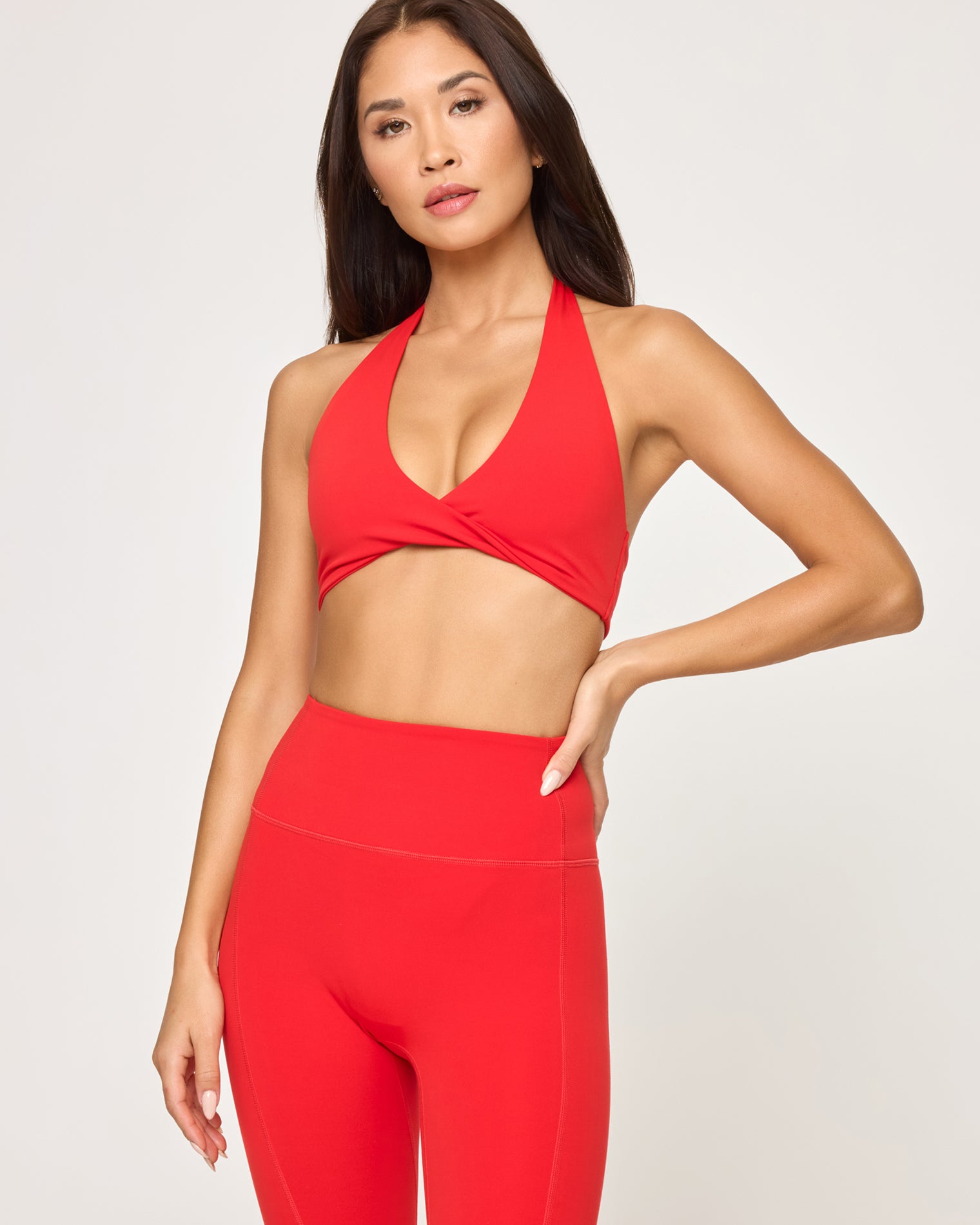 Level Up Legging - Flame Close-up front view of model wearing the Level Up Legging in flame showing the waistband detail, with matching flame Jeanne Bra.