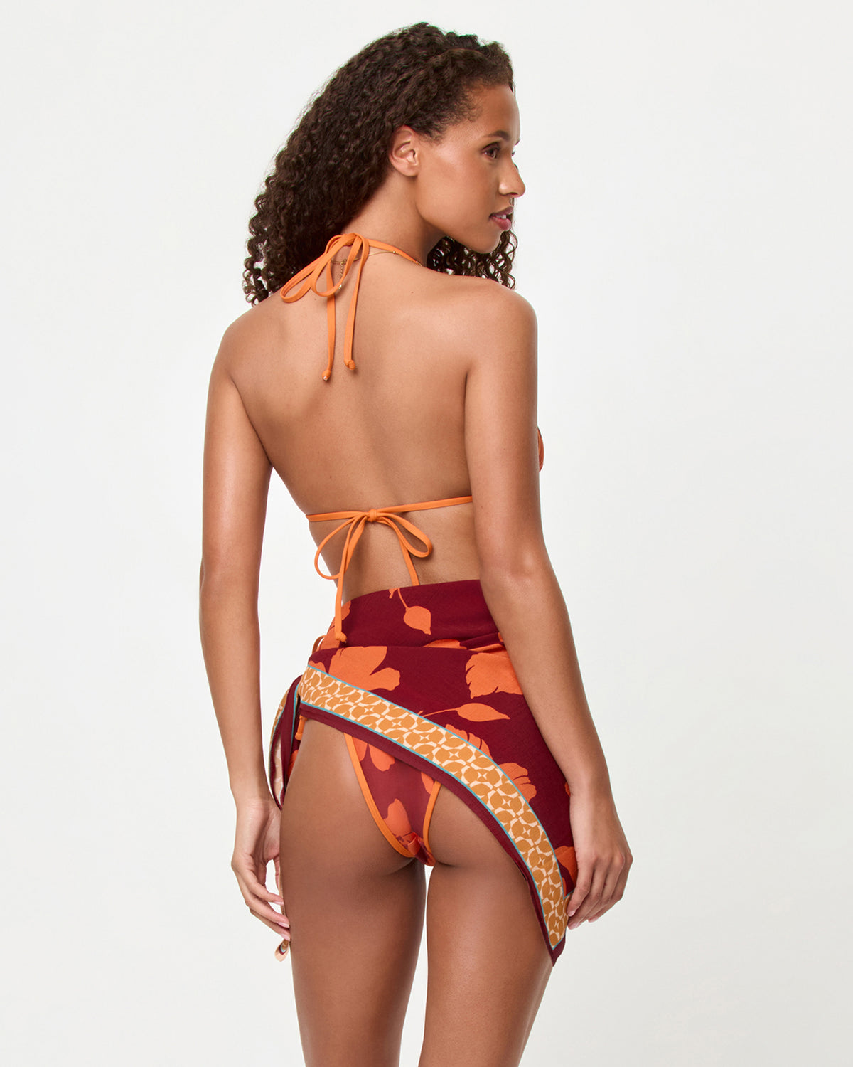 Momi Scarf - Cocobolo LSPACE Momi scarf in Cocobolo print, back view on model, tied in a mini skirt.