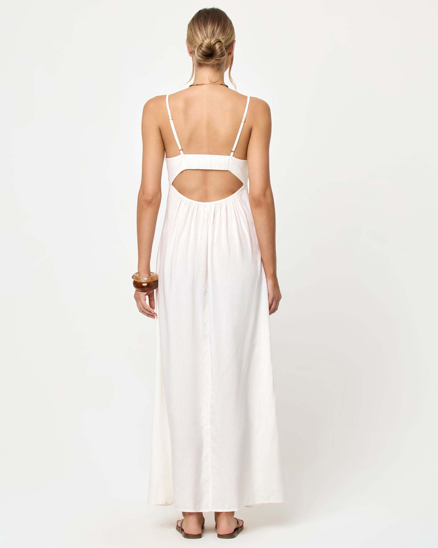Chara Maxi Dress - Cream Back view of model wearing the LSPACE Chara Maxi Dress in cream, showing the open back with thin spaghetti straps.