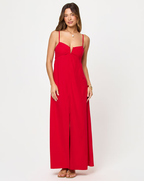 Front view of model wearing the LSPACE Chara Maxi Dress in lipstick red, a floor-length sleeveless maxi dress with a deep V bustier-style neckline and front center slit.