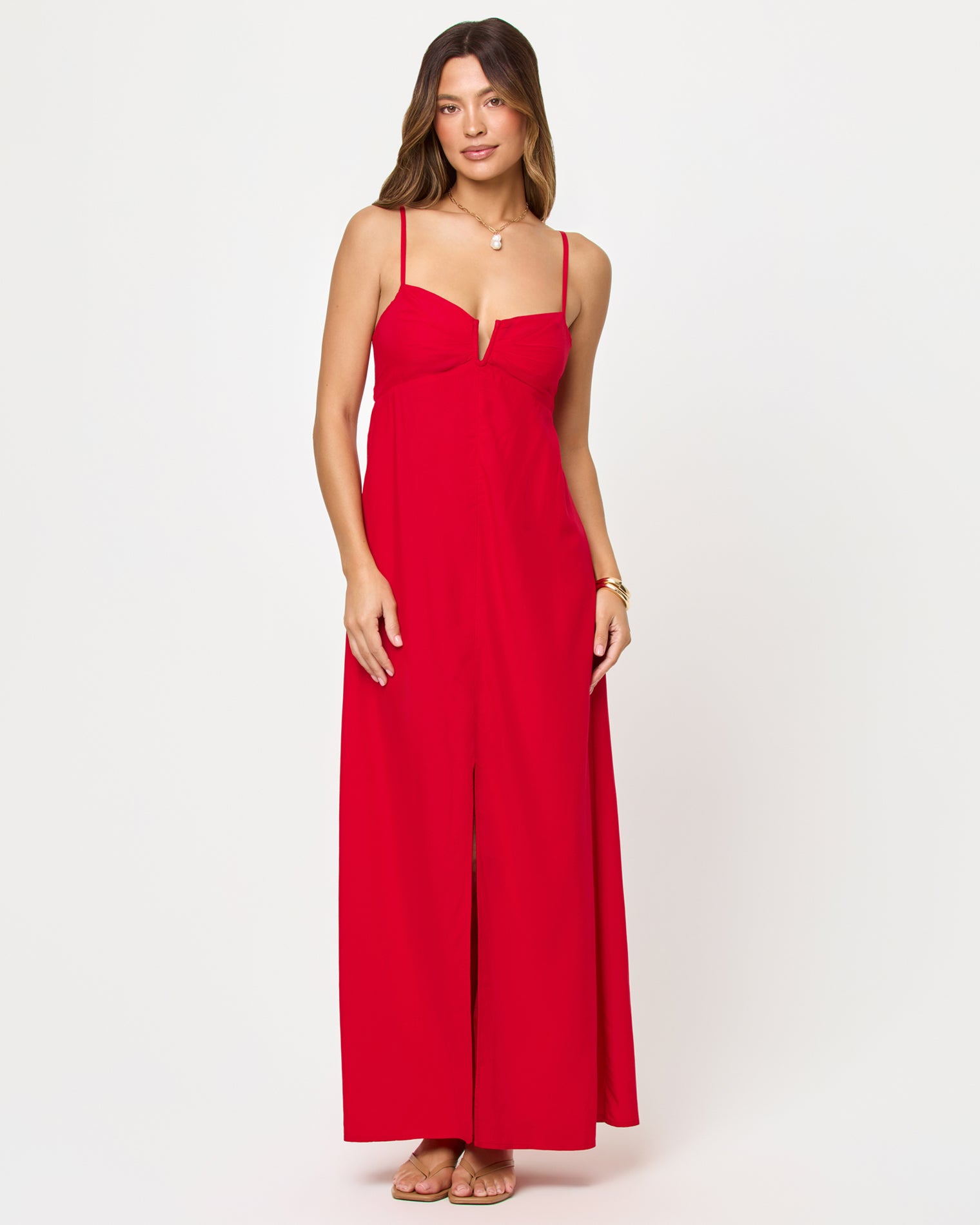 Chara Maxi Dress - Lipstick Red Front view of model wearing the LSPACE Chara Maxi Dress in lipstick red, a floor-length sleeveless maxi dress with a deep V bustier-style neckline and front center slit.