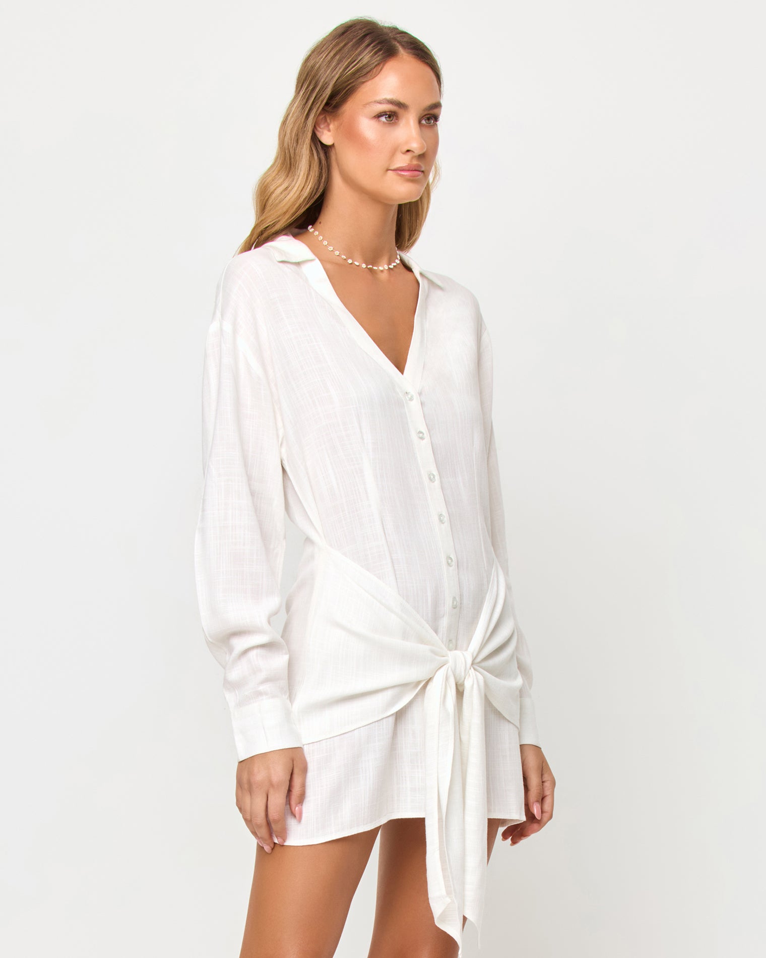 Vera Mini - Cream LSPACE Vera mini dress in cream, three-quarter view on model.