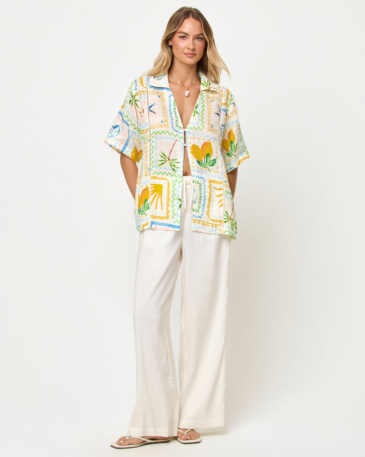 La Mer Shirt - Wish You Were Here LSPACE La Mer shirt in Wish You Were Here print, front view on model styled with wide-leg pants.