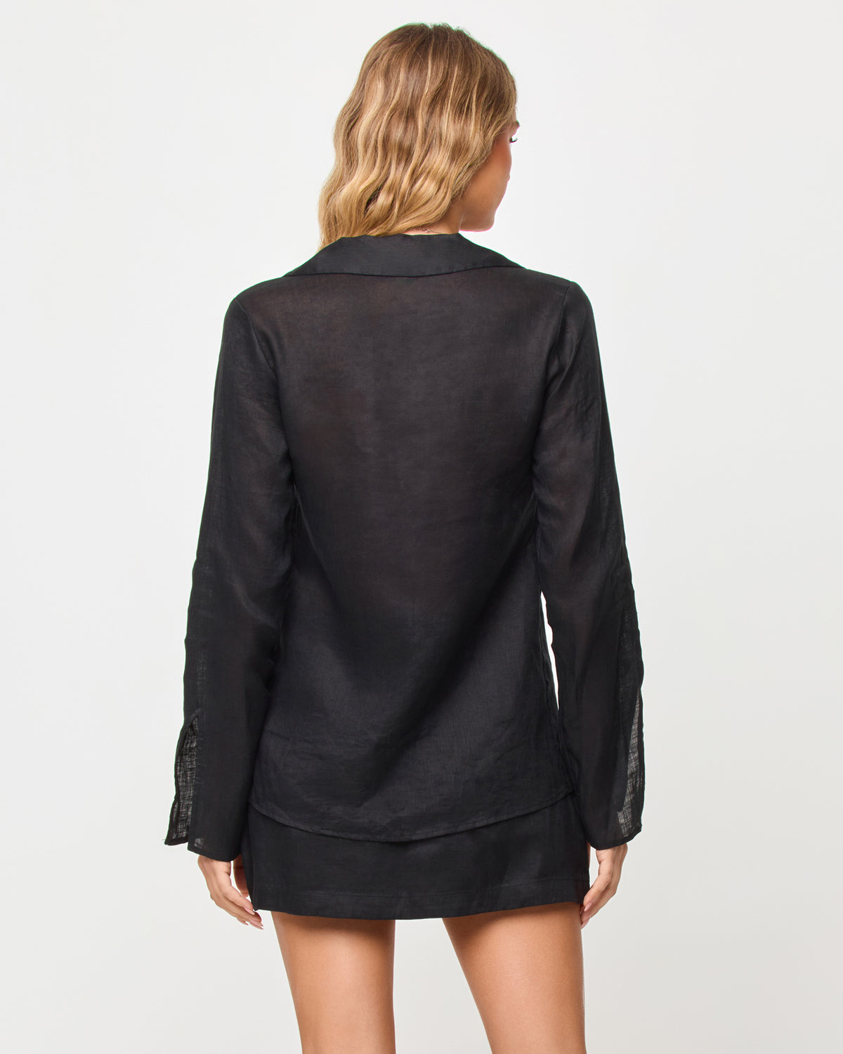 Venice Skort - Black Person wearing a black top and skirt set on a plain background
