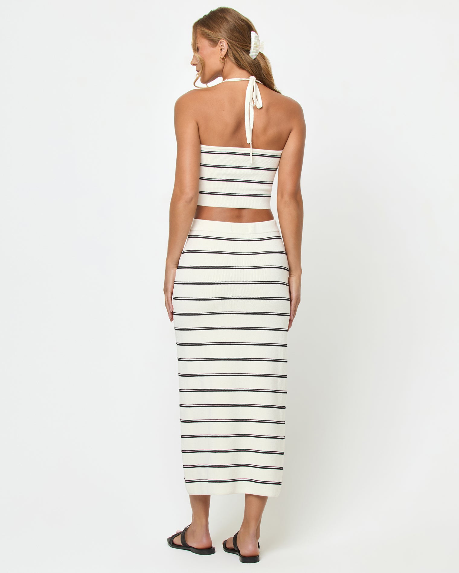 Ravello Skirt - Mykonos Stripe Back view of a model wearing the LSPACE Ravello Skirt in mykonos stripe, showing the fitted silhouette and cream and black horizontal stripe pattern, styled with the matching Positano Top.