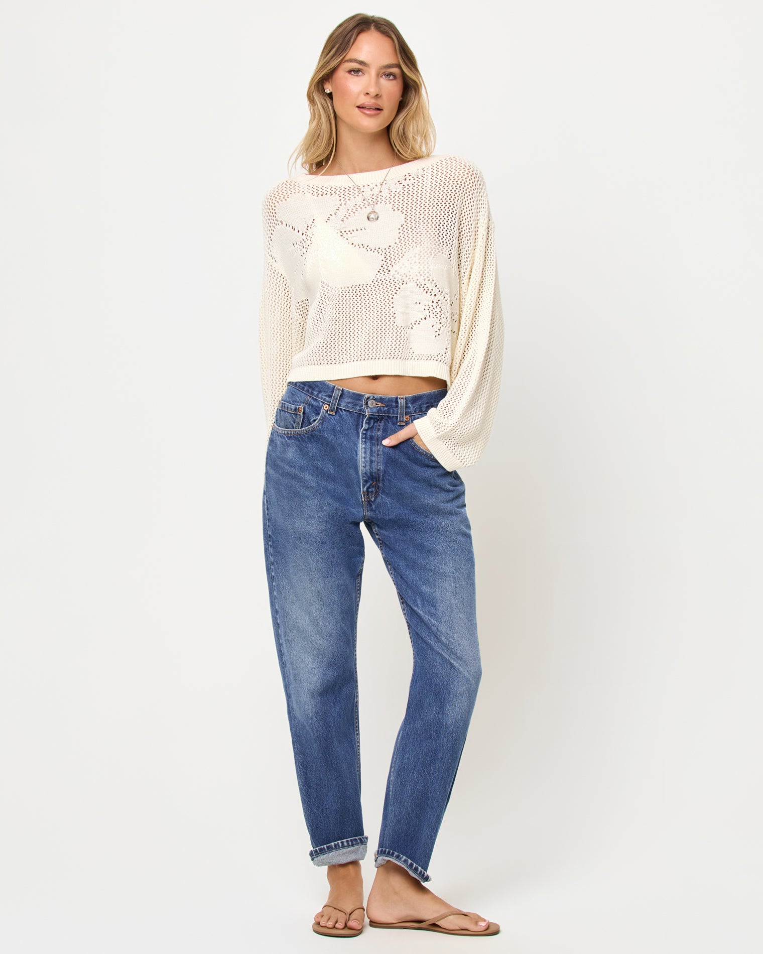 Island Time Sweater - Cream Woman wearing a white crochet top and blue jeans on a white background