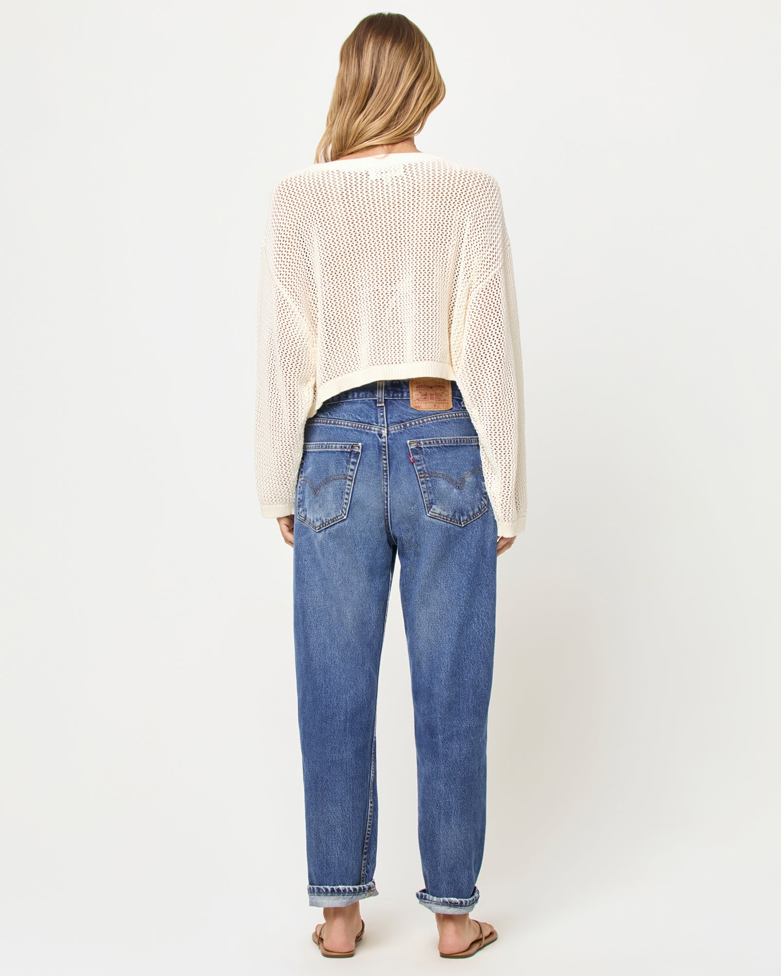 Island Time Sweater - Cream Person wearing a cream sweater and blue jeans on a white background