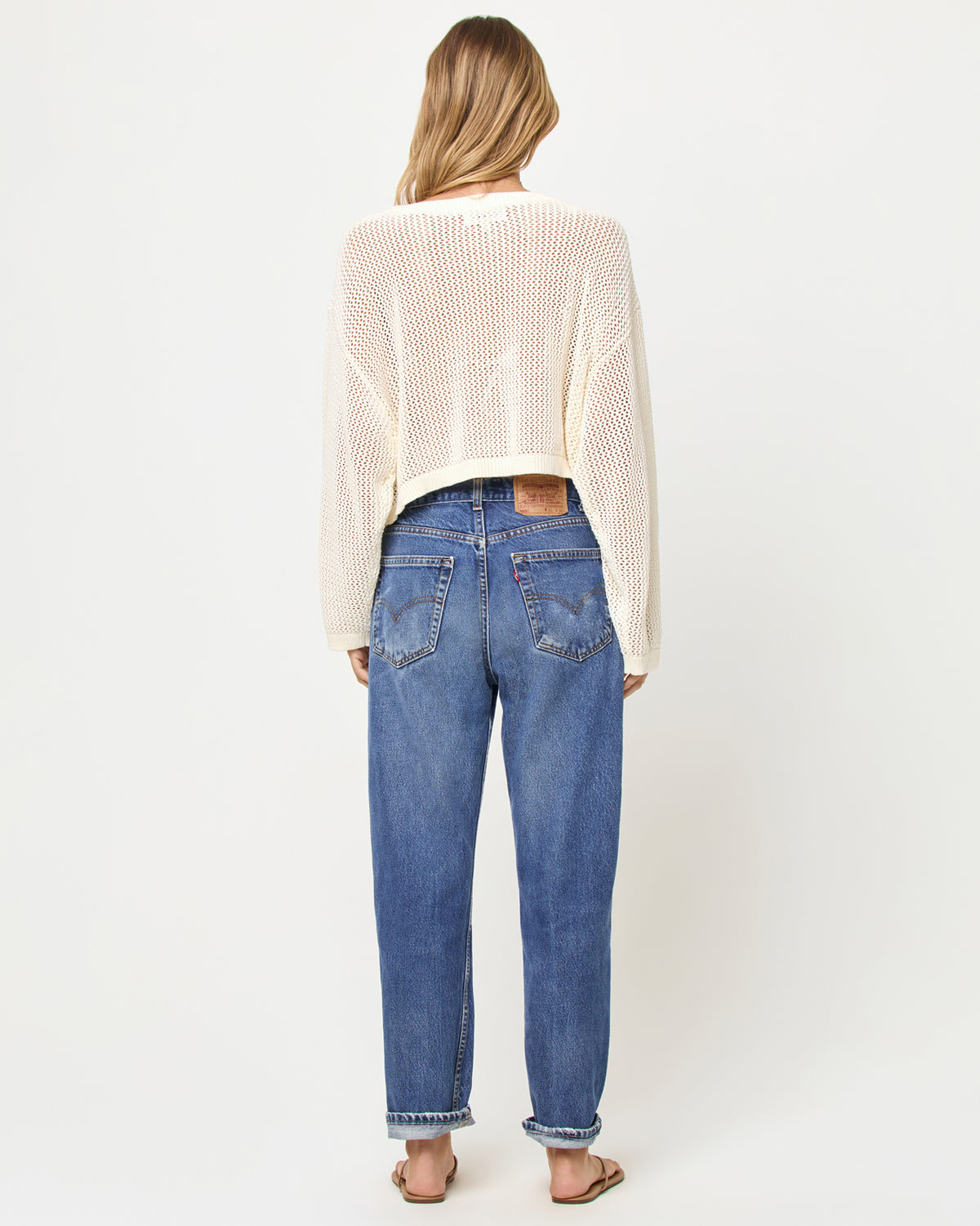 Island Time Sweater - Cream Person wearing a cream sweater and blue jeans on a white background
