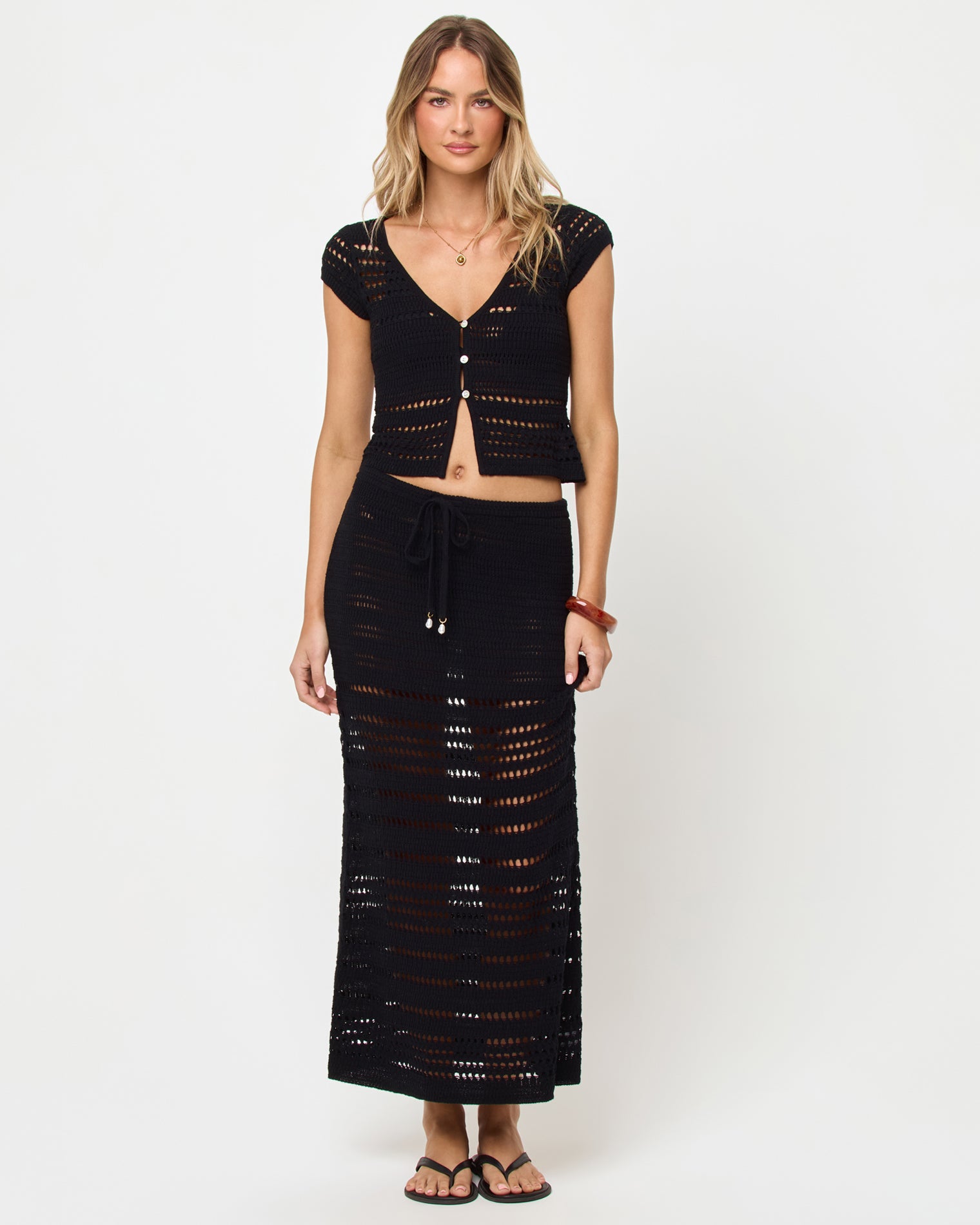 Tula Top - Black Woman wearing a black crochet top and skirt set on a white background