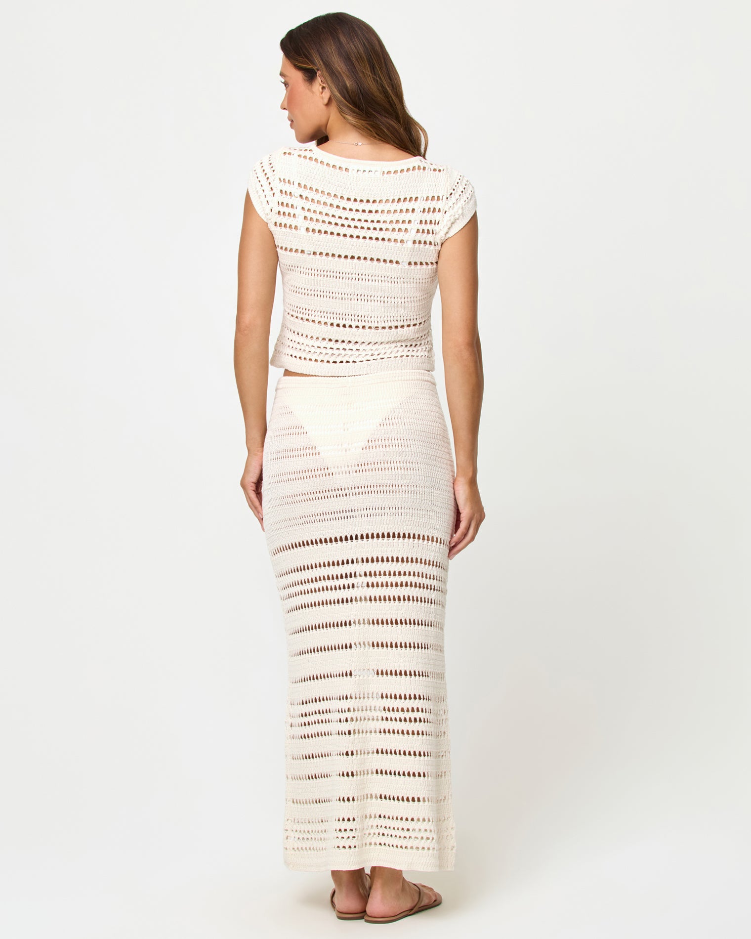 Tula Skirt - Cream Woman wearing a white crochet outfit on a plain background