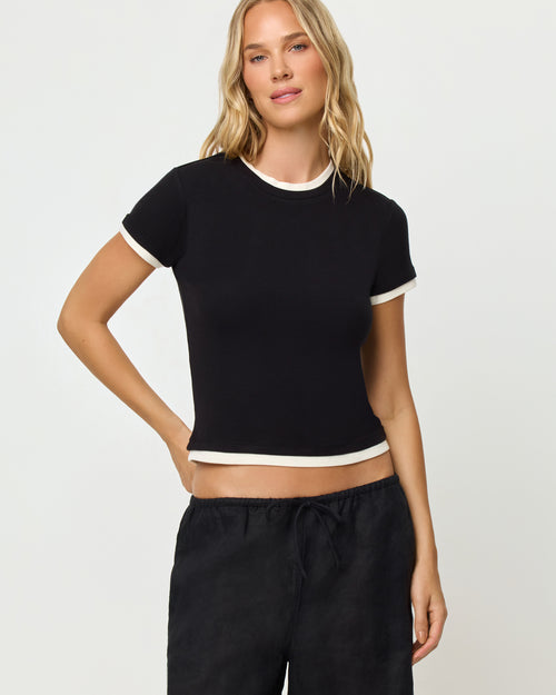 Model wearing the Range top in Black-Cream, paired with the Nina Pant