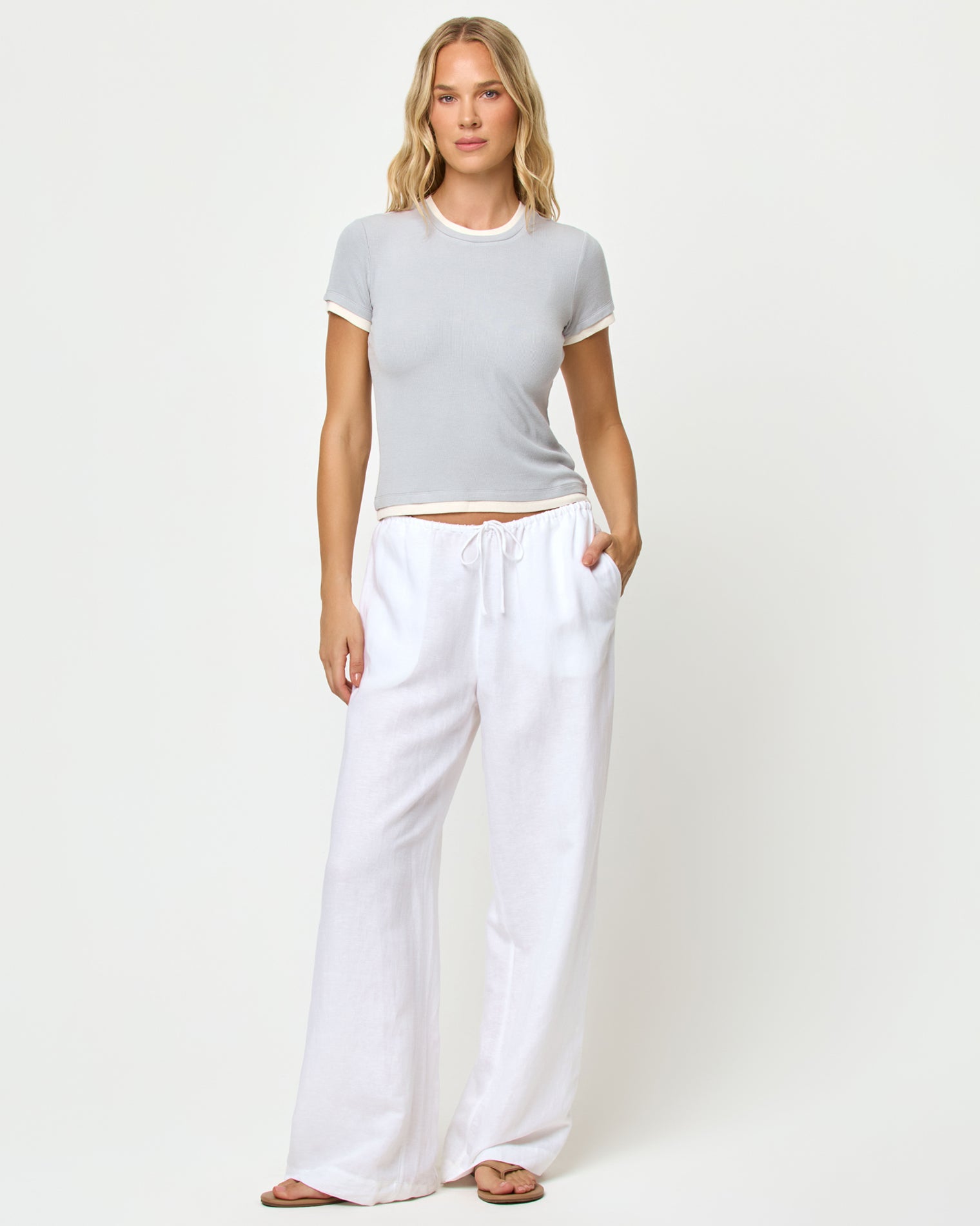 Range Top - Gray-Cream Front view of model wearing the Range top in gray-cream, styled with the Nina Pant in white.
