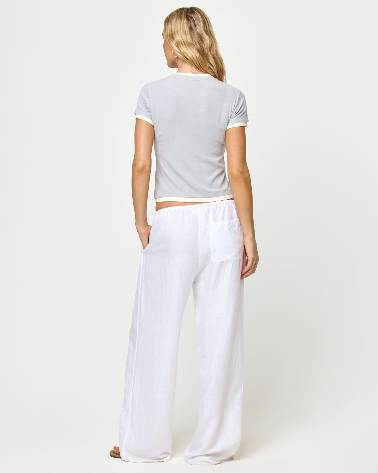 Range Top - Gray-Cream Back view of model wearing the Range top in gray-cream, styled with the Nina Pant in white.