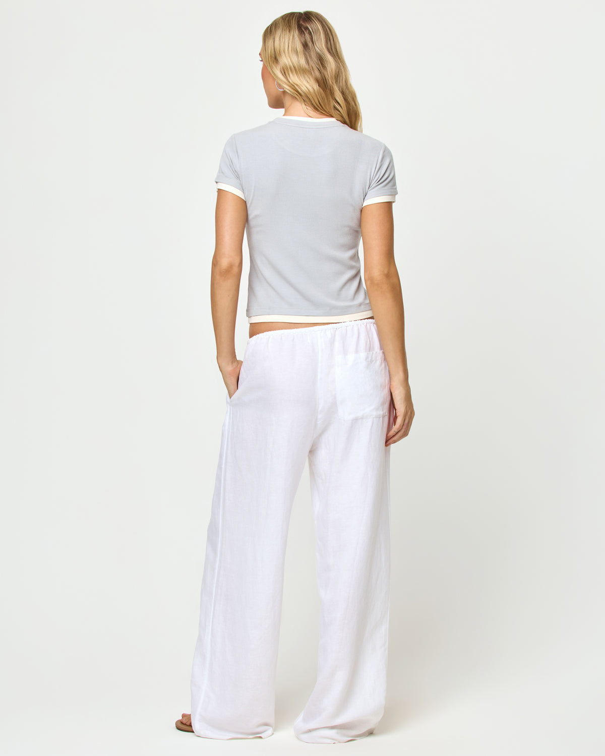 Range Top - Gray-Cream Back view of model wearing the Range top in gray-cream, styled with the Nina Pant in white.