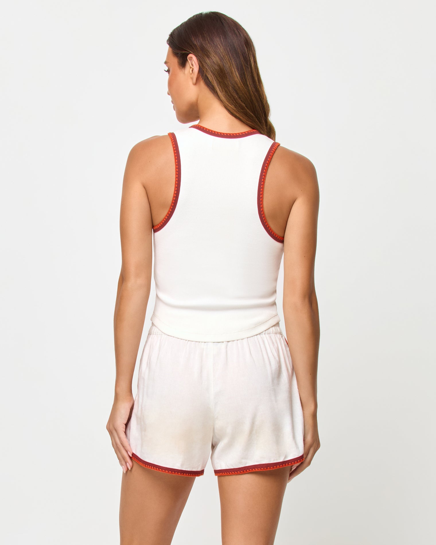 Rune Short - Cream Fig Poppy Back studio view of the Ash Tank and Rune Short in Cream Fig Poppy, a cream ribbed crop tank with rust and terracotta crochet trim at the back neckline and racerback straps paired with matching cream runner shorts with rust crochet trim at the hem.