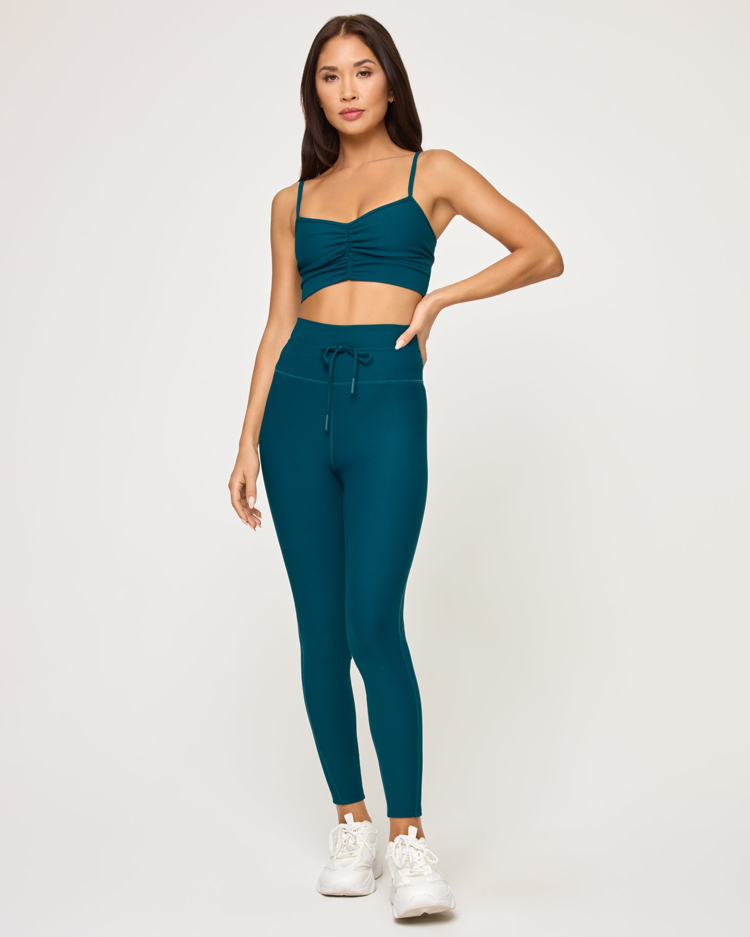 Soren Top - Deep Teal Front view of model wearing the Soren Top in deep teal with matching deep teal Turner Legging and white sneakers.