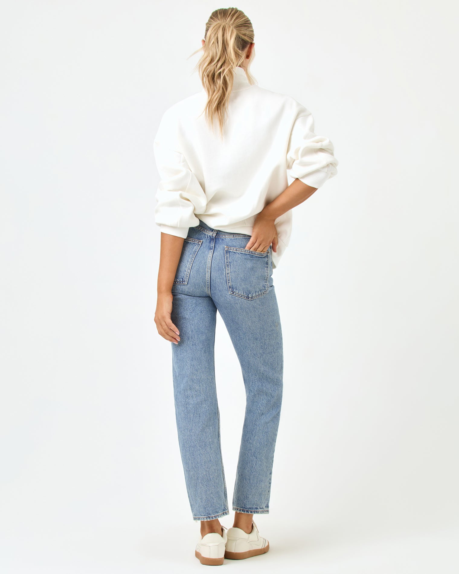 Crush Sweatshirt - Cream Back full-length studio view of the Crush Sweatshirt in cream, a cream quarter-zip pullover sweatshirt, styled with blue jeans and white sneakers.