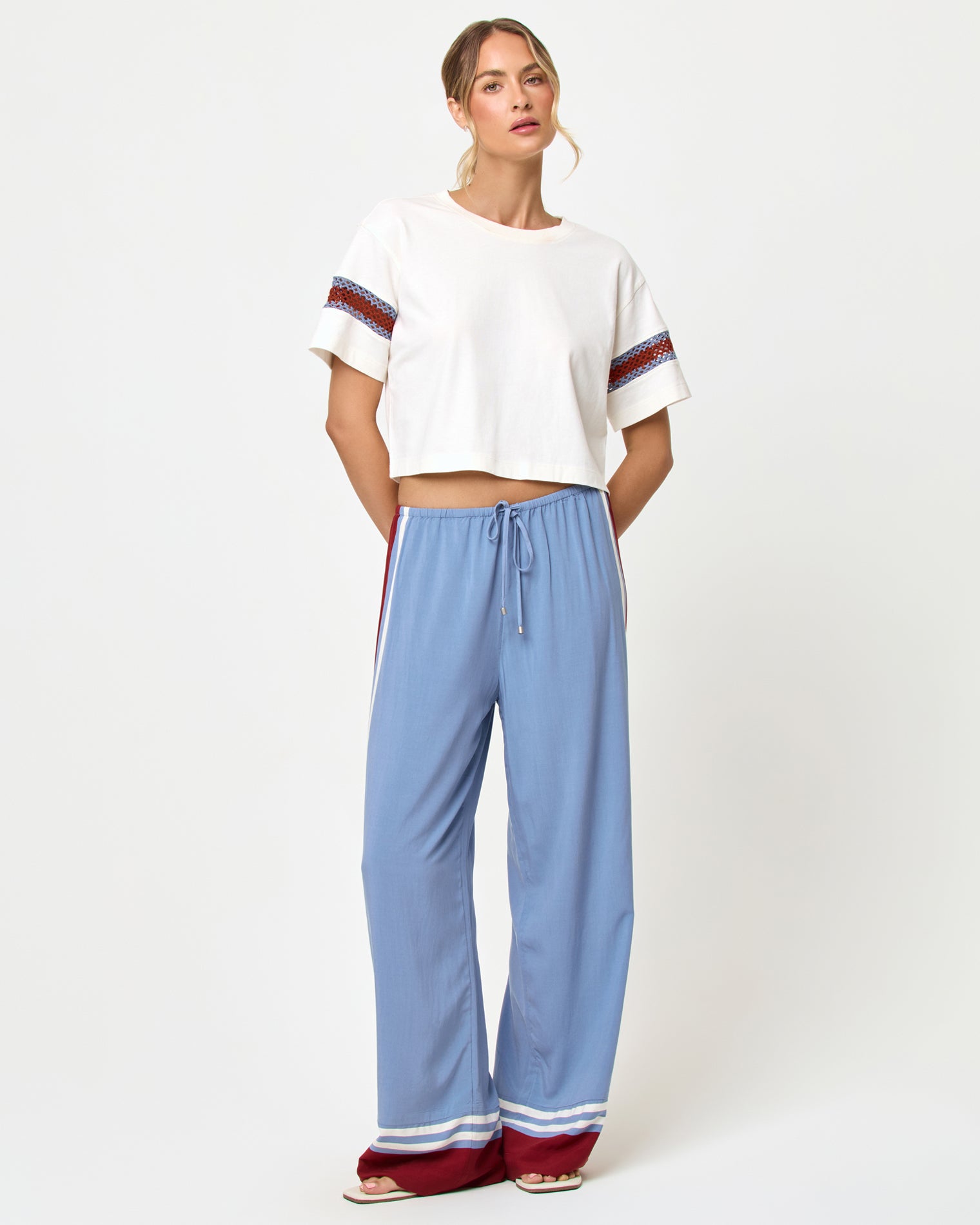 Unwind Pant - Unwind Stripe Front view of model wearing the LSPACE Unwind Pant in unwind stripe, a relaxed wide-leg striped pant with drawstring waist.