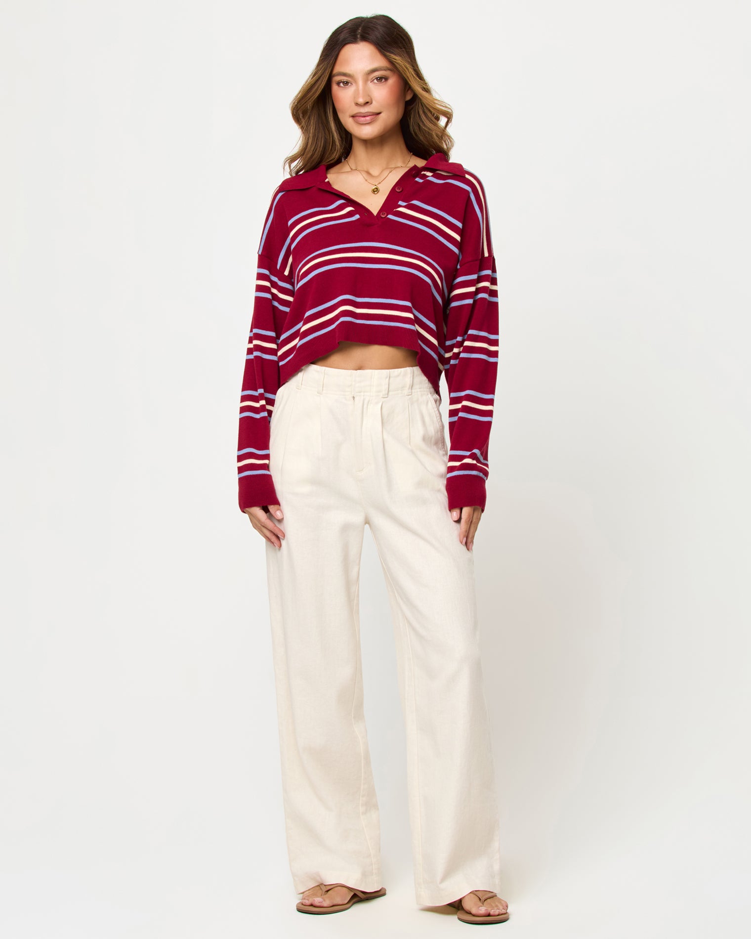 Dalton Sweater - Berry Wine Stripe LSPACE Dalton sweater in berry wine stripe, styled with pants, front view on model.