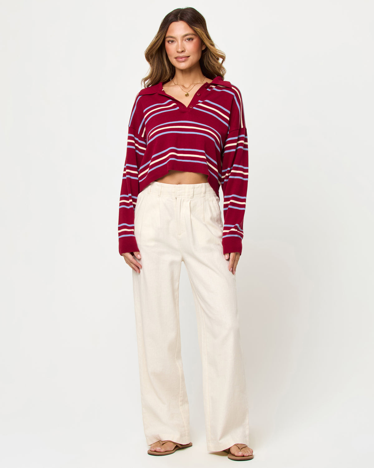 Dalton Sweater - Berry Wine Stripe LSPACE Dalton sweater in berry wine stripe, styled with pants, front view on model.