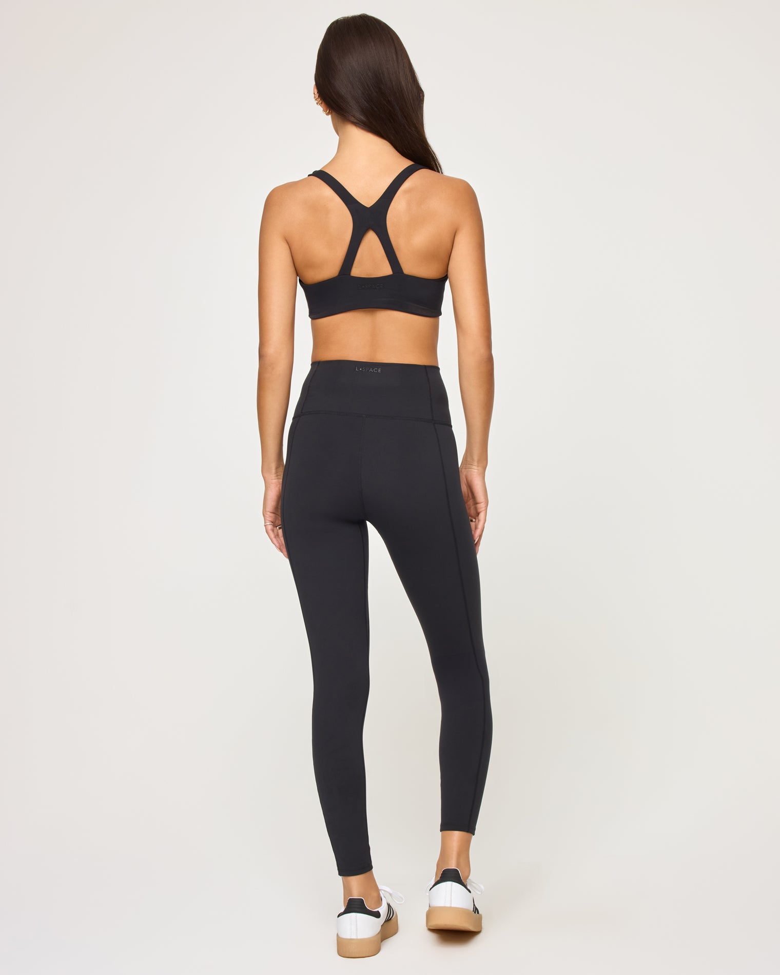 Contender Legging - Black Back view of model wearing the Contender Legging in black with matching black sports bra.