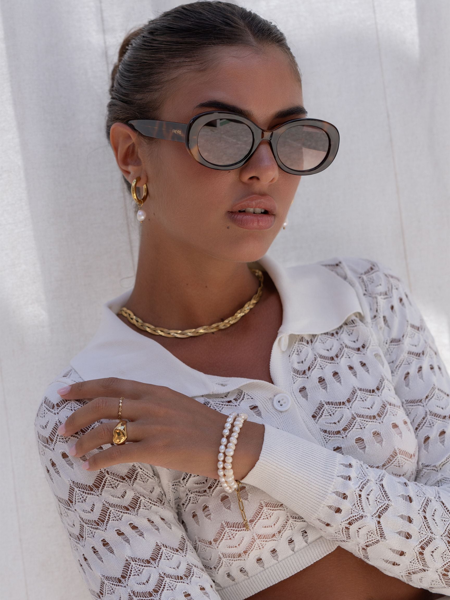 Freyrs Aria Sunglasses - Brown Close-up of model wearing the Freyrs Aria Sunglasses in brown.