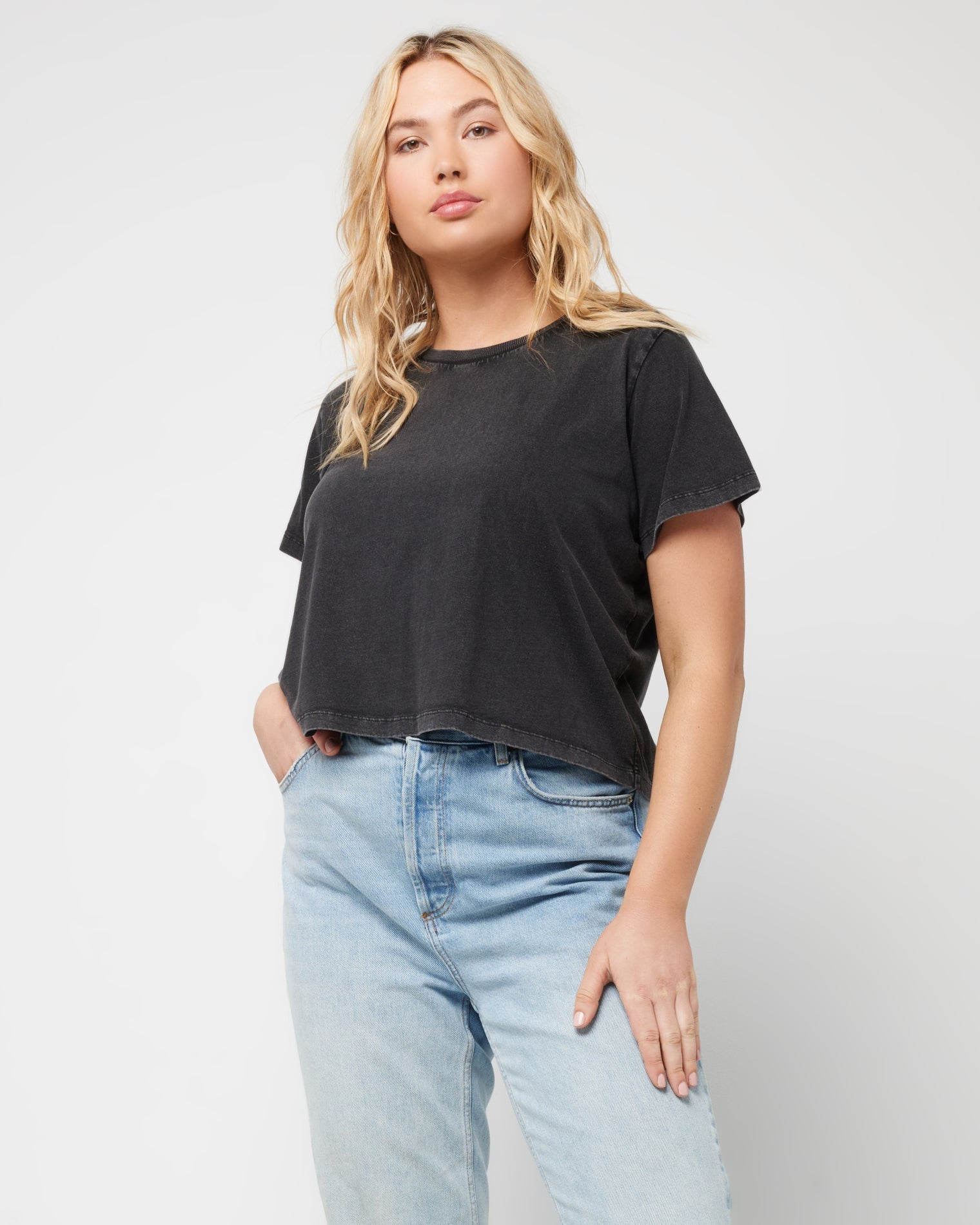 All Day Top - Black Front view of a model wearing the LSPACE All Day Top in black, styled with light wash jeans.