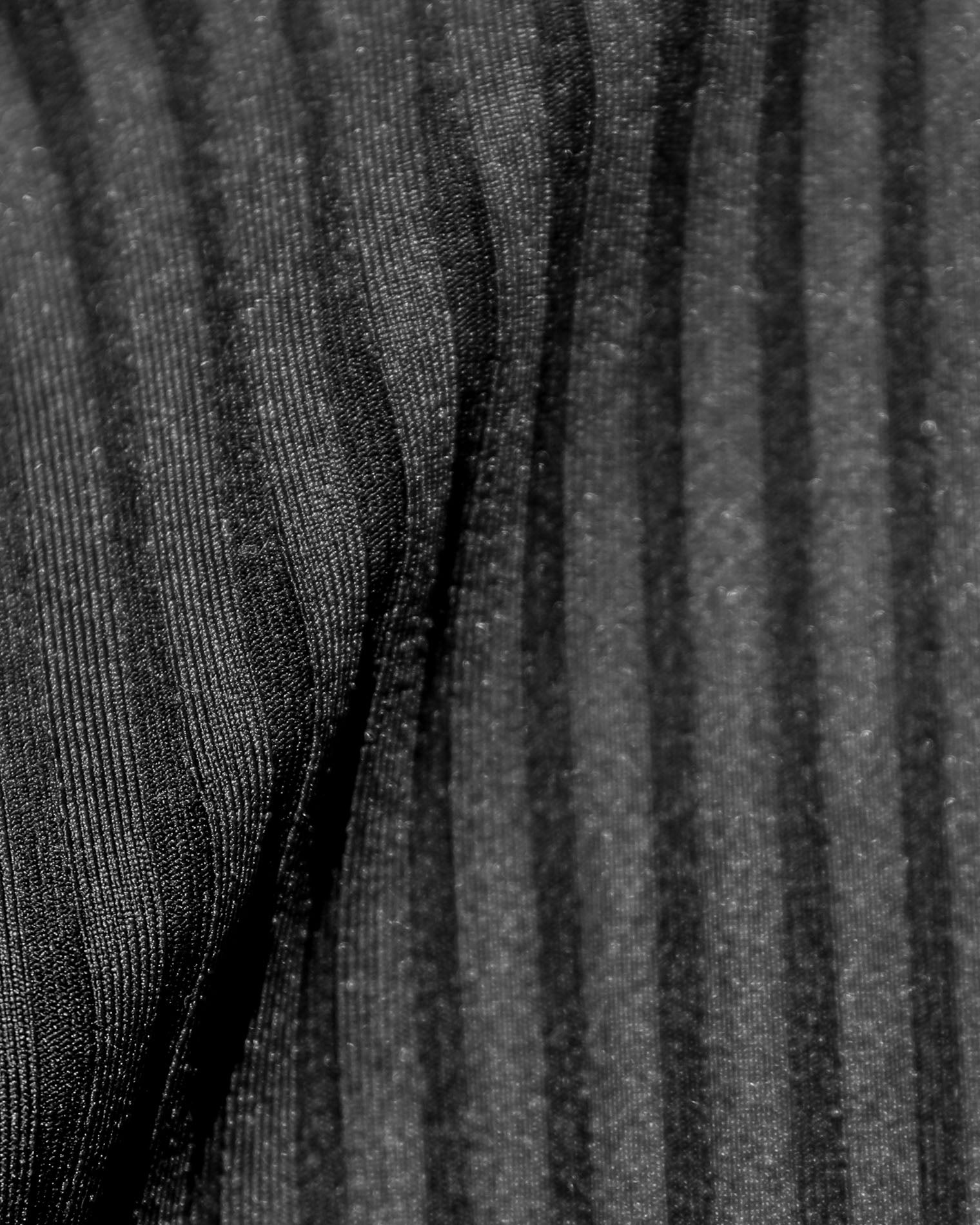 Effie Bikini Top - Black Close-up detail of the black ribbed eco-friendly fabric texture of the LSPACE Effie Bikini Top, off-model.