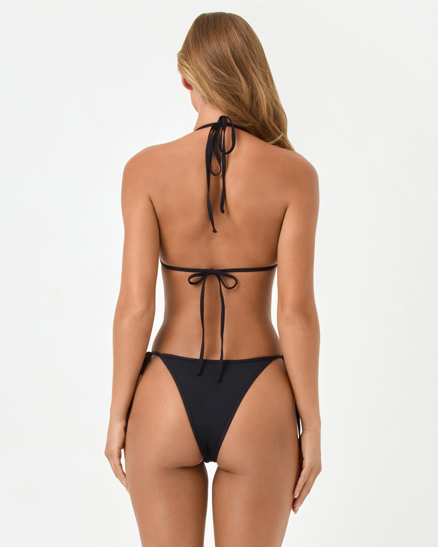 Levy Bikini Bottom - Black Back view of a model wearing the LSPACE black Aspen Bikini Top and Levy Bikini Bottom showing the cheeky cut and side ties.