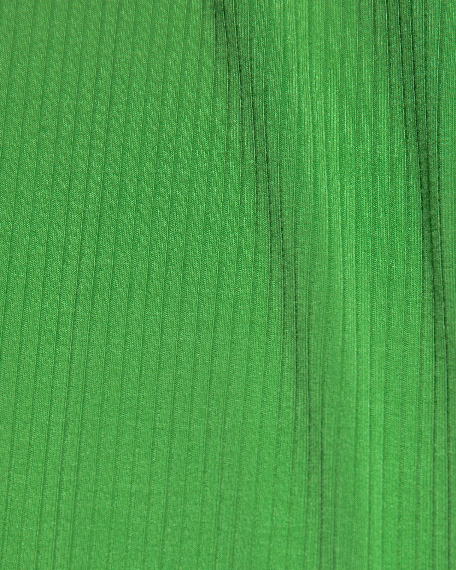 Jordana Dress - Clover-Cream Close-up of the LSPACE Jordana Dress in clover-cream, highlighting the clover green ribbed knit fabric texture.