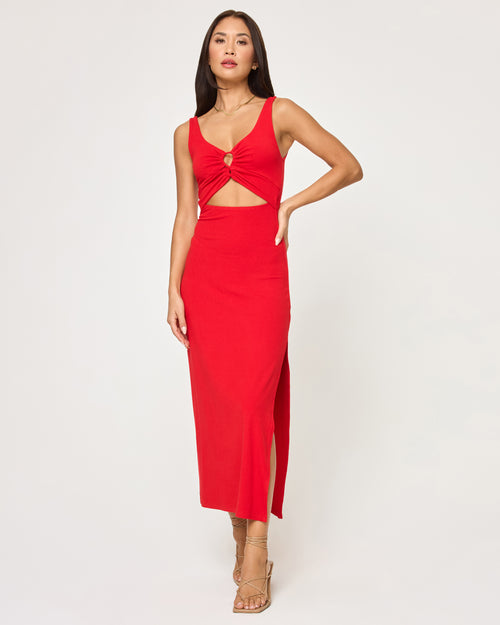 Full-length view of a model wearing the LSPACE Camille Dress in flame, a sleeveless midi dress with a V-neckline, keyhole bust cutout, side waist cutout, and leg slit.