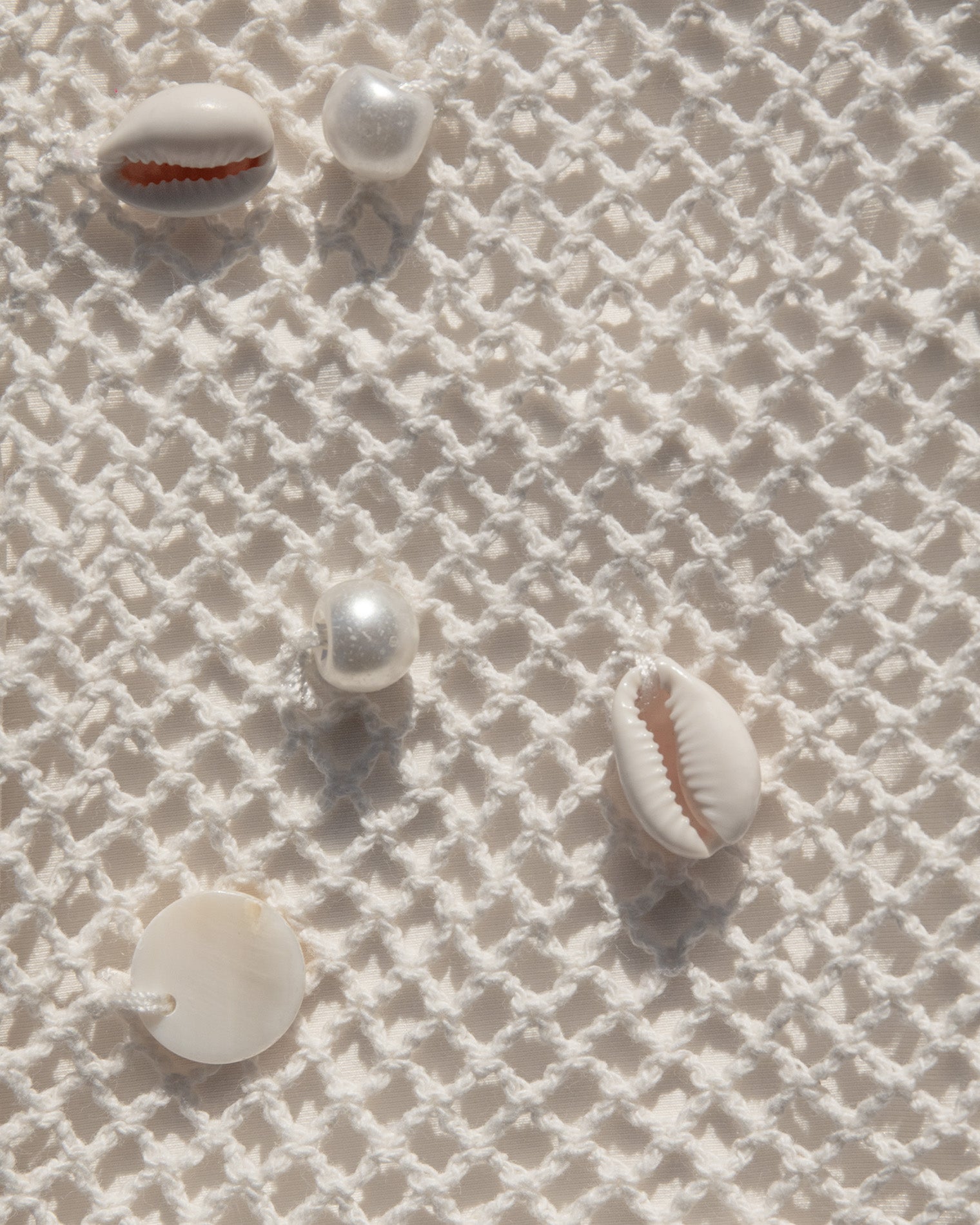 Close up of seashell adorned crochet fabric