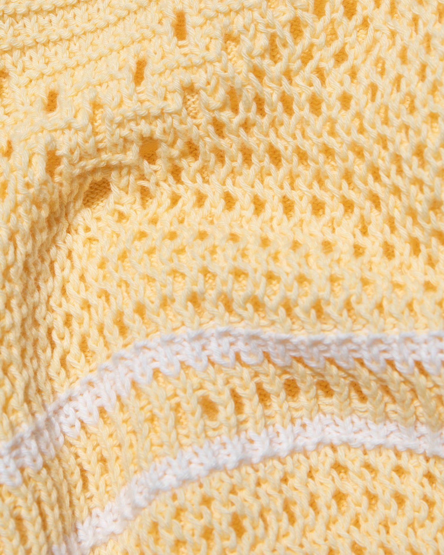 Heart To Heart Dress - Daisy-Cream Close-up of the LSPACE Heart To Heart Dress in daisy-cream, showing the open-knit crochet fabric texture in soft yellow with a horizontal cream stripe detail.