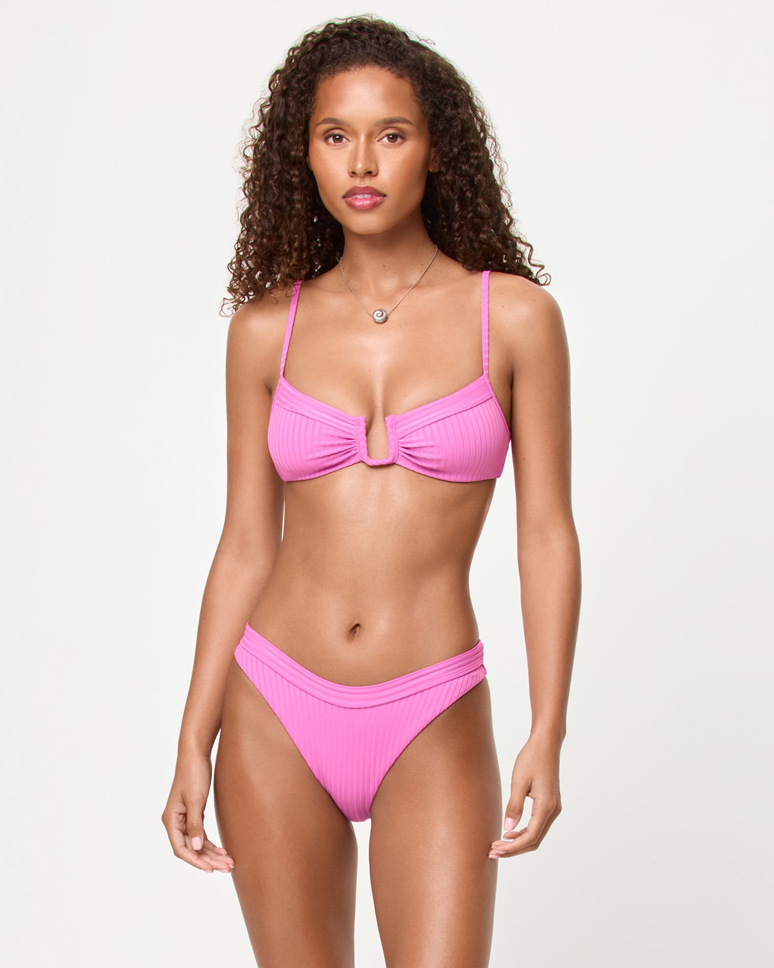 Mercer Bikini Bottom - Sweetheart Front view of a model wearing the LSPACE Sweetheart Mercer Bikini Bottom with ribbed fabric and banded waistband.
