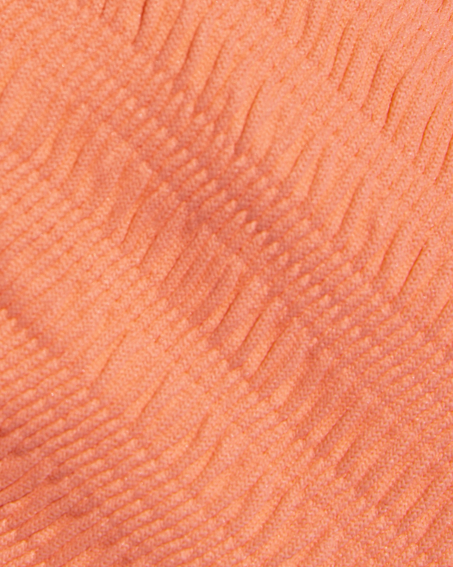Leilani Bikini Bottom - Fresh Squeezed Close-up detail of the Fresh Squeezed fabric texture of the LSPACE Leilani Bikini Bottom, showing the peach-orange ribbed swimwear material.