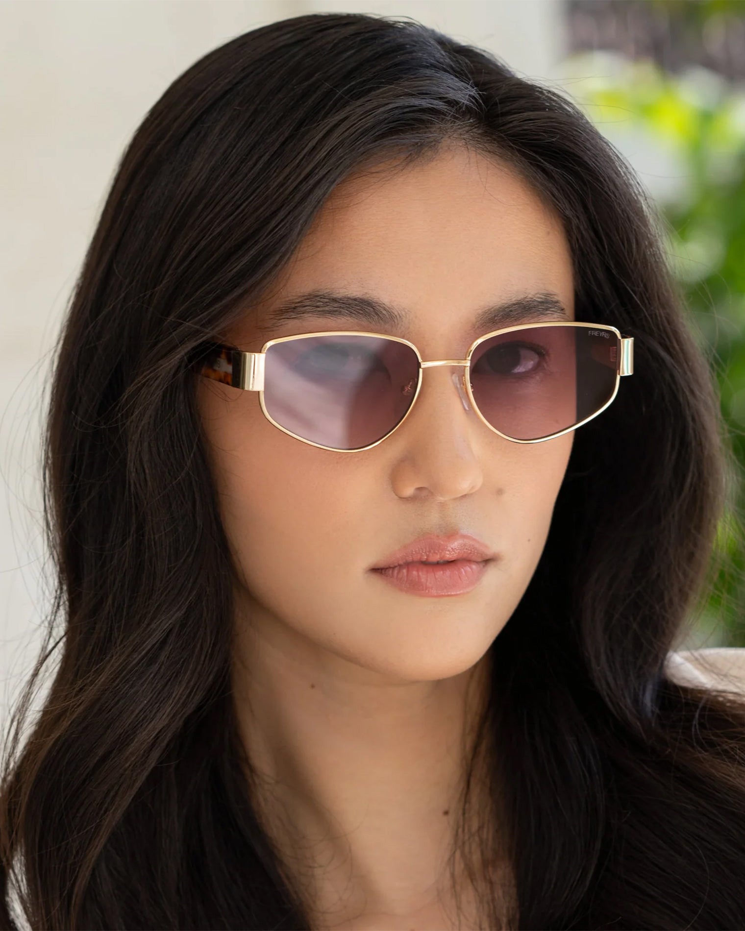 Freyrs Delilah Sunglasses - Gold Close-up of model wearing the Freyrs Delilah Sunglasses in gold.