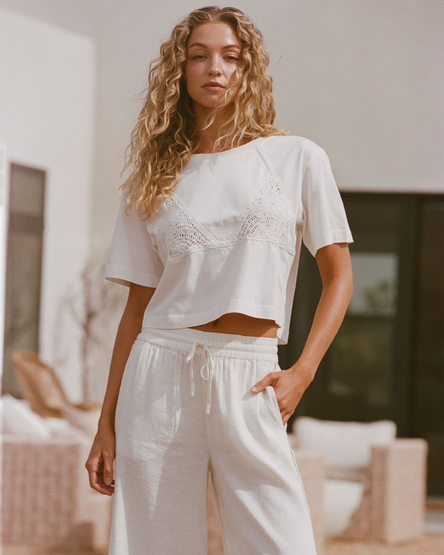 Core Top - Cream-Natural Cream Natural | Badge:New Arrival_#B2AC88_#ffffff'
Lifestyle image of model wearing the LSPACE Core Top in cream-natural, a cropped short-sleeve top in cream.
