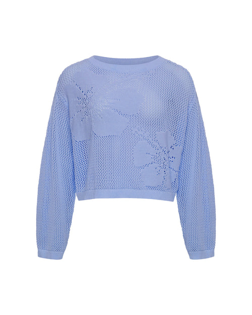 Off-model view of the LSPACE Island Time Sweater in Chambray, a cropped open-knit crochet pullover with a floral motif and long sleeves.