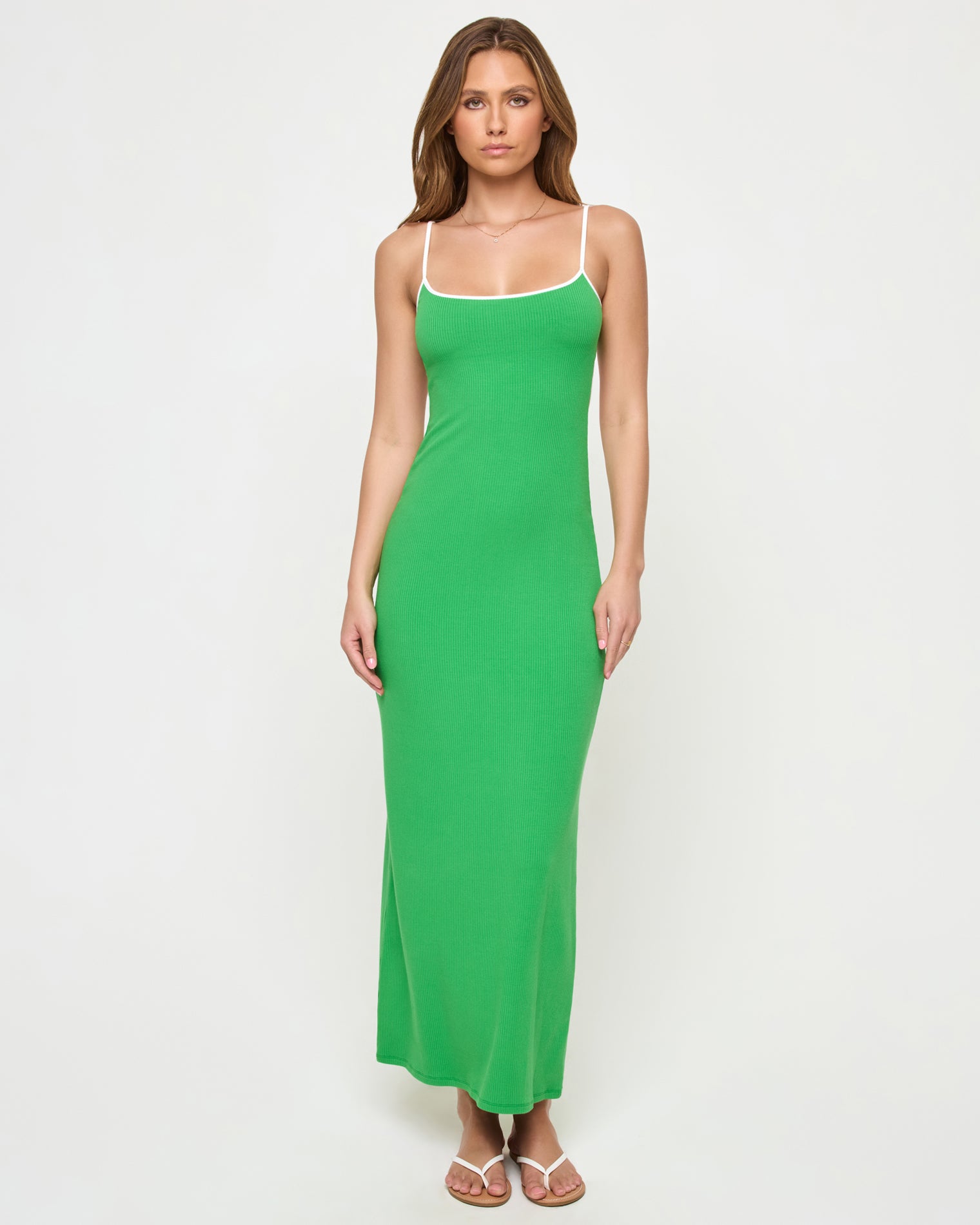 Jordana Dress - Clover-Cream Full-length front view of a model wearing the LSPACE Jordana Dress in clover-cream, a form-fitting ribbed maxi dress in clover green with cream contrast trim at the neckline and spaghetti straps.