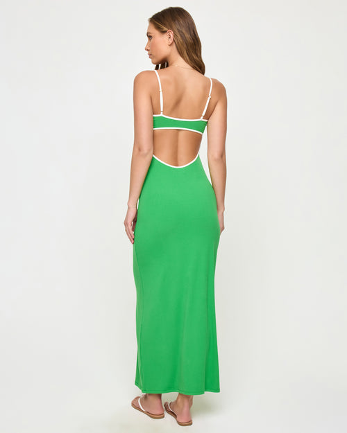 Back view of a model wearing the LSPACE Jordana Dress in clover-cream, showing the open back design with cream contrast trim framing the cutout.