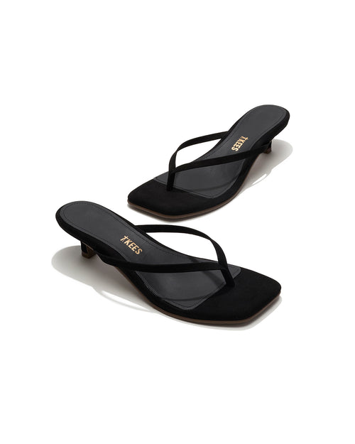 Angled view of both black suede TKEES Square Toe Julia sandals with gold TKEES logo on footbed.