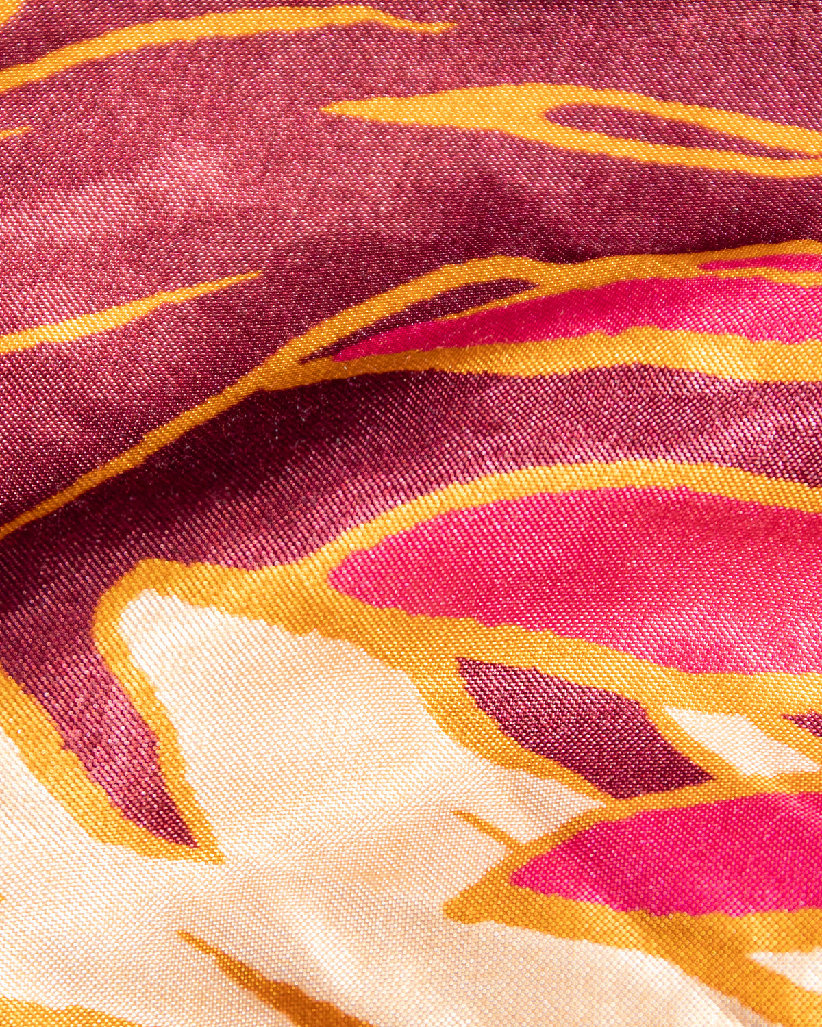 With Love Maxi - Leaf It To Me A close-up of a patterned fabric with an abstract design in deep magenta, bright pink, cream, and mustard yellow.