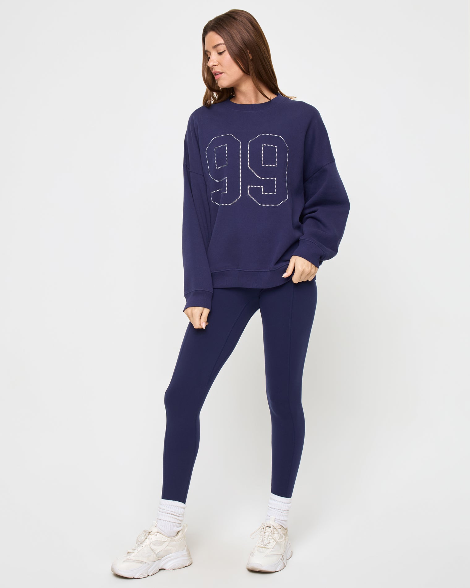 Legend Sweatshirt - Midnight Blue Angled view of the LSPACE Legend Sweatshirt in midnight blue on a model against a light background, showing the rhinestone graphic detail.