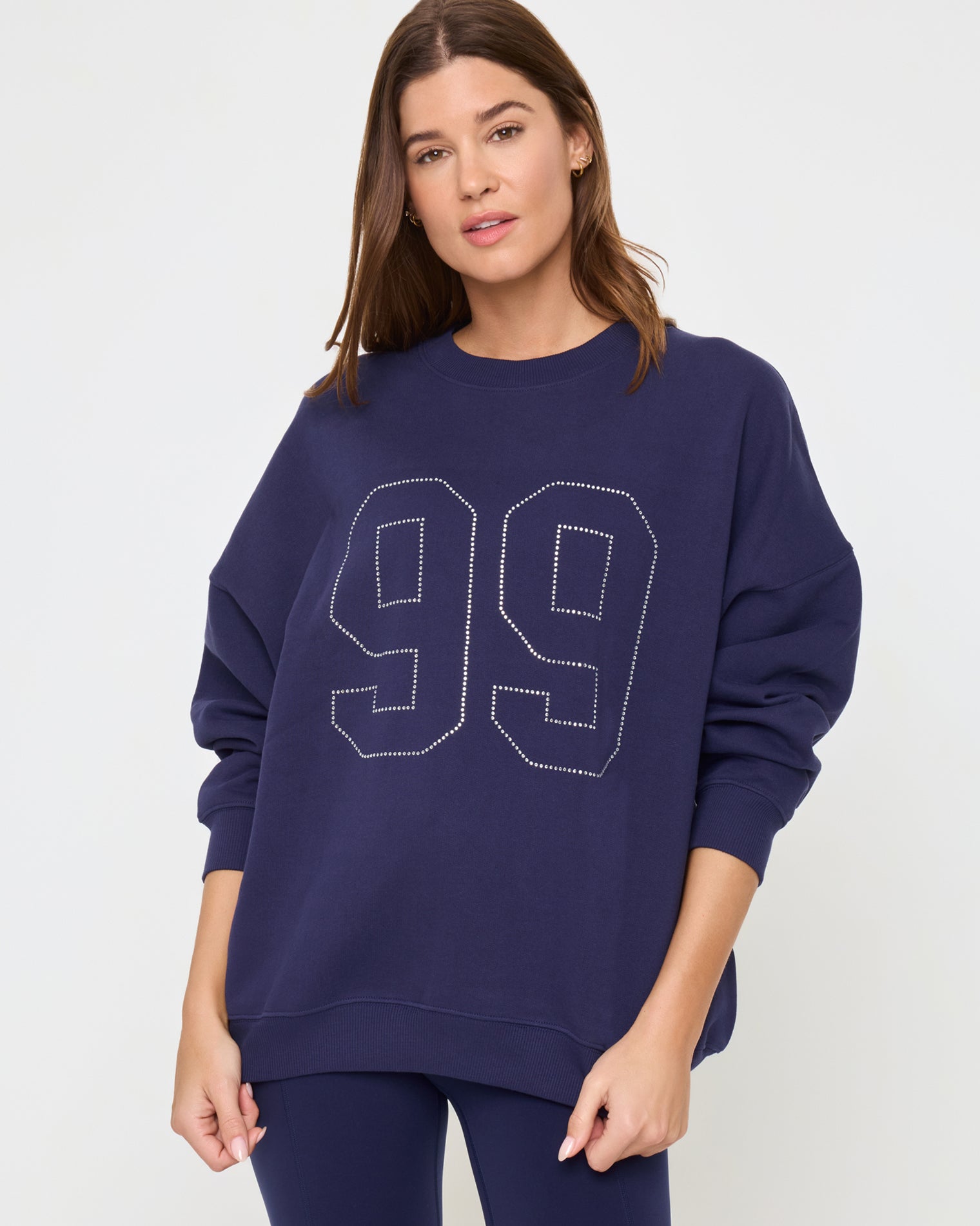 Legend Sweatshirt - Midnight Blue Close-up detail view of the LSPACE Legend Sweatshirt in midnight blue on a model, showing the rhinestone graphic and fabric detail of the cropped oversized sweatshirt.