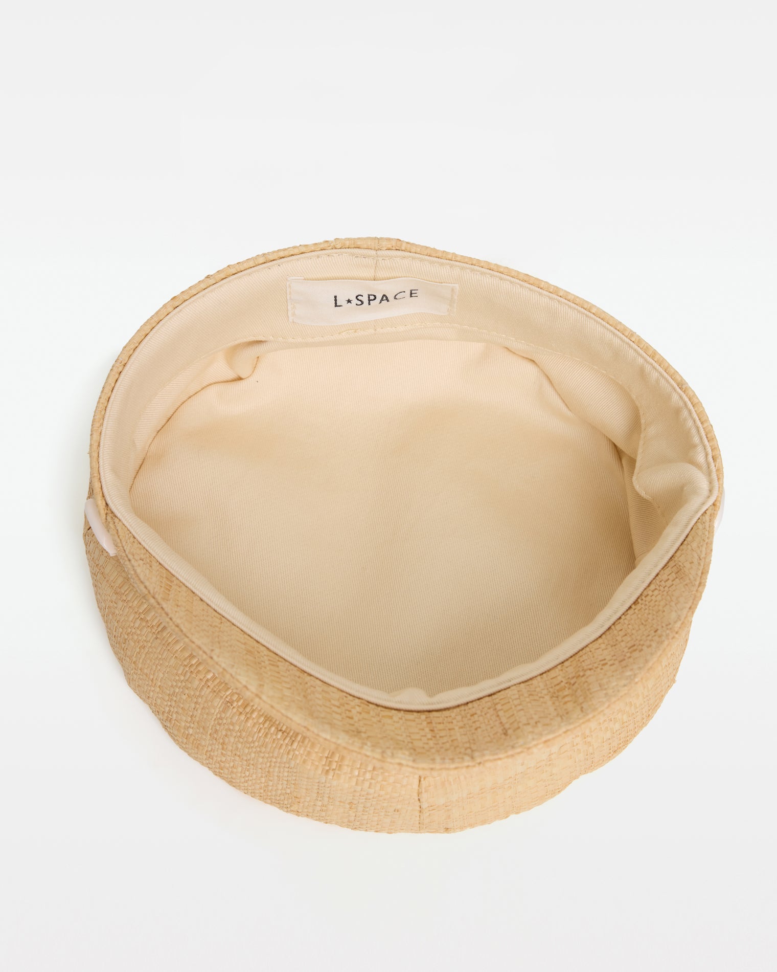 Alfama Cap - Natural Top-down interior view of the Alfama Cap in natural showing the cream lining and LSPACE branding label.