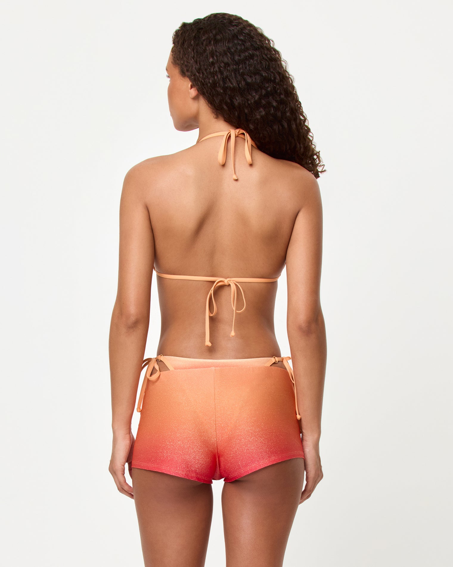 Caliente Short - Ocaso Back view of a model wearing the LSPACE Ocaso Caliente Short with the matching Banning Bikini top.