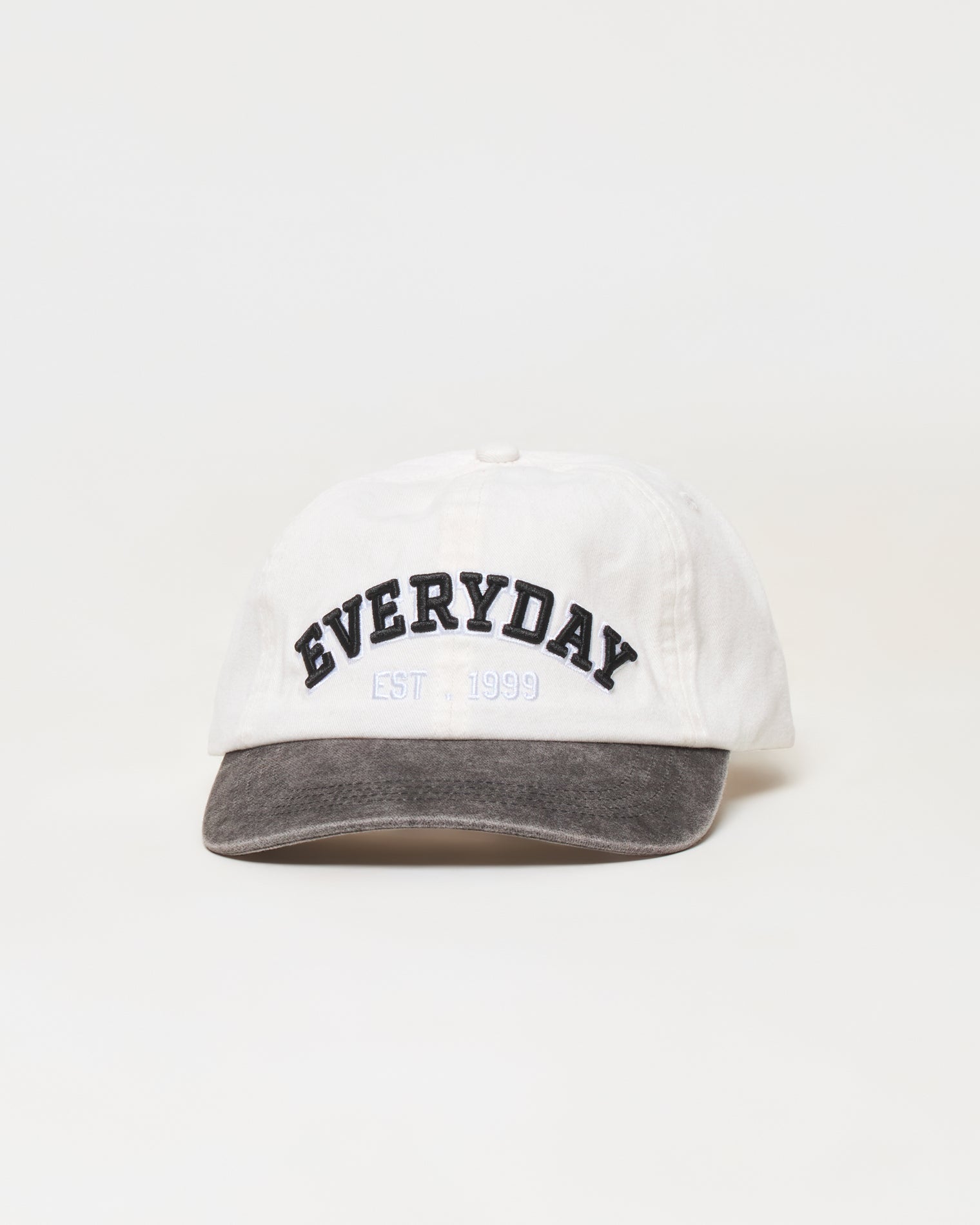 Buns Out Hat - Everyday Everyday | Badge:New Arrival_#B2AC88_#ffffff'

A white baseball cap with a dark gray washed brim, featuring 'EVERYDAY EST. 1999' embroidered on the front in black and light blue.
