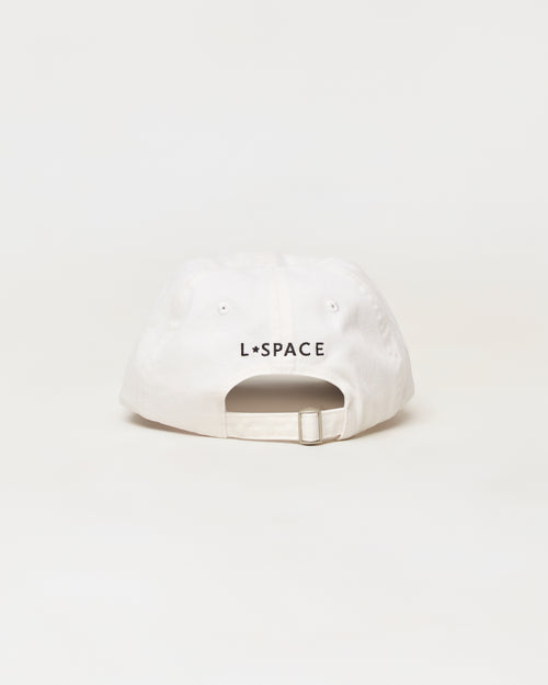 A white baseball cap shown from the back, featuring the black text 'L*SPACE' printed across the center. The cap has a curved brim, eyelets, and an adjustable snapback strap, photographed against a seamless white background.